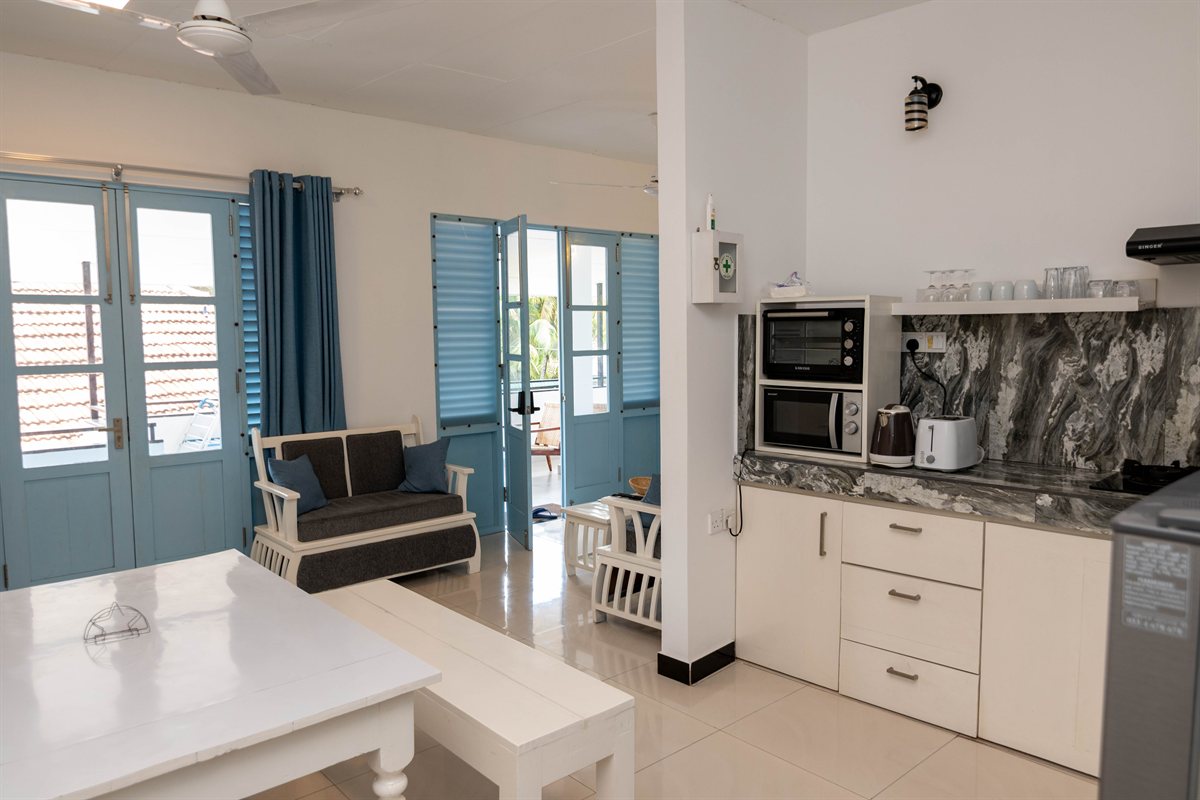 Private kitchen, dining table and sitting area at Tropical Palm View Retreat