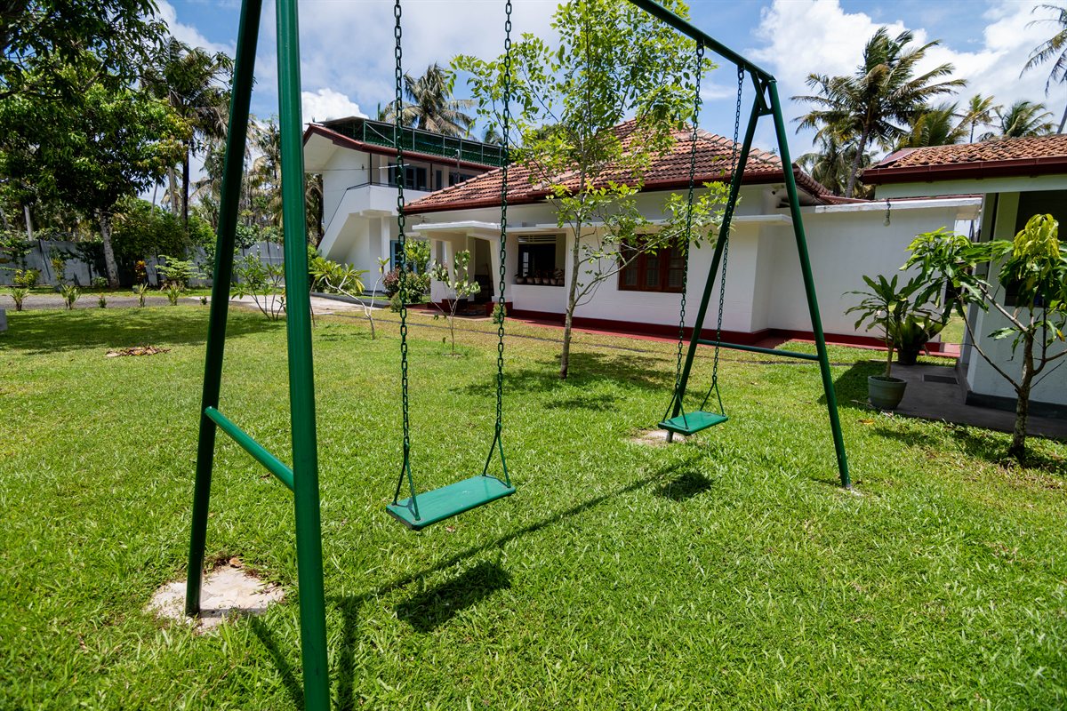Garden swings on the shared lawn between the three retreats at Dimuthu Ahangama